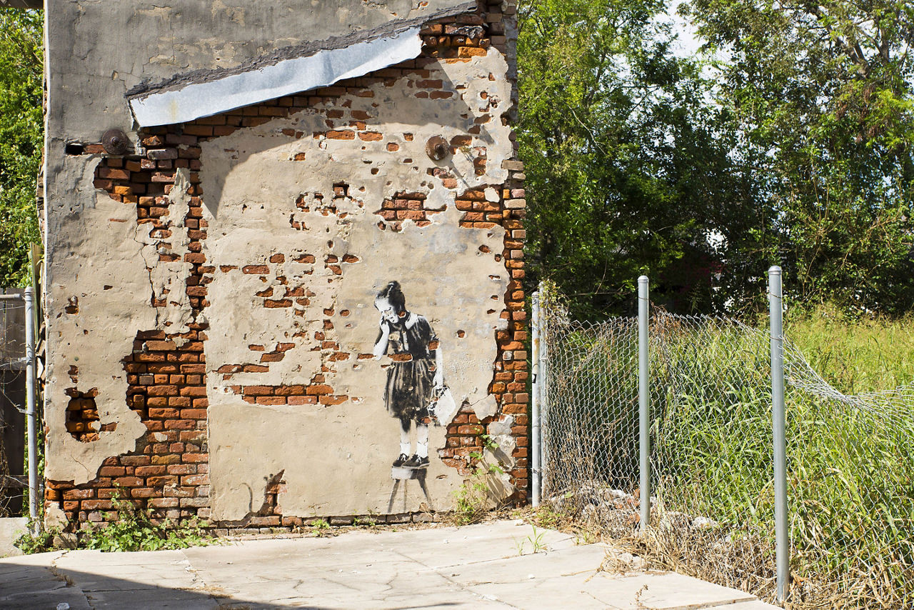 Graffiti artist Banksy on a destroyed house Hurricane Katrina in New Orleans - "Rat and a girl"
