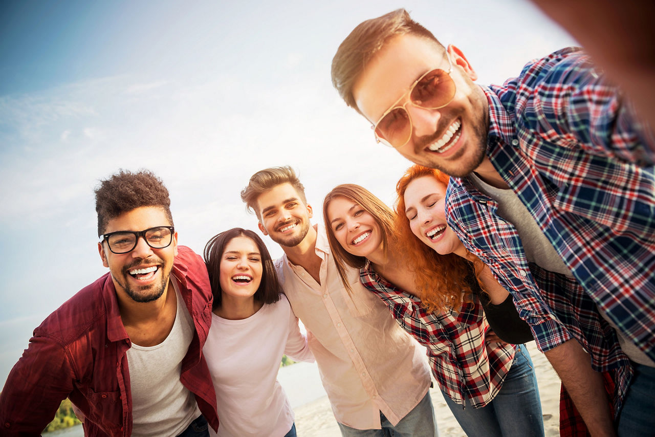 Group of adults taking a selphie.