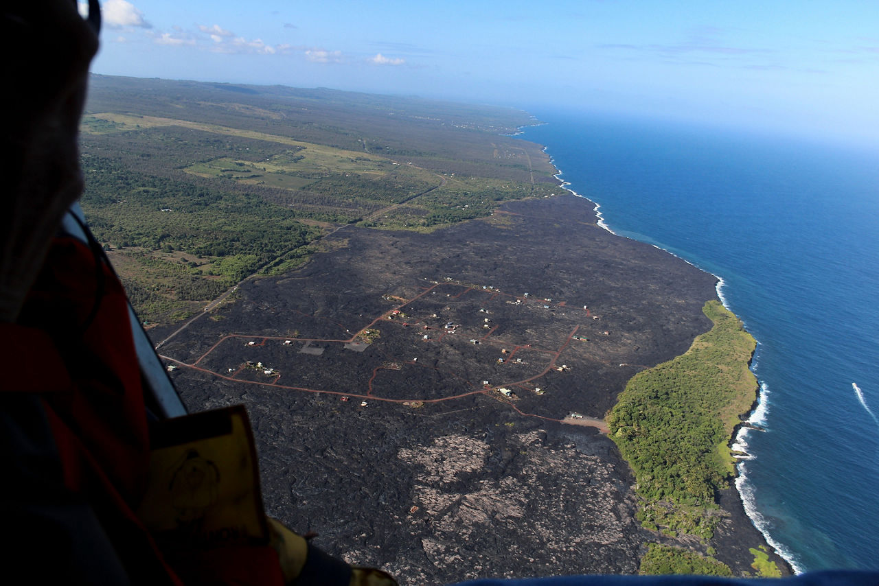 Helicopter aerial view of lava field by the ocean, Big Island, Hawaii