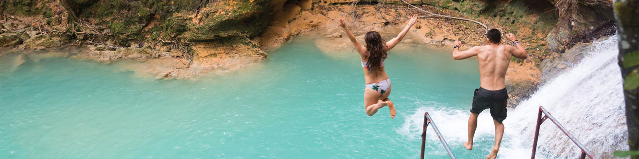 Jamaica Waterfalls Couple Jumping in the Natural Pools