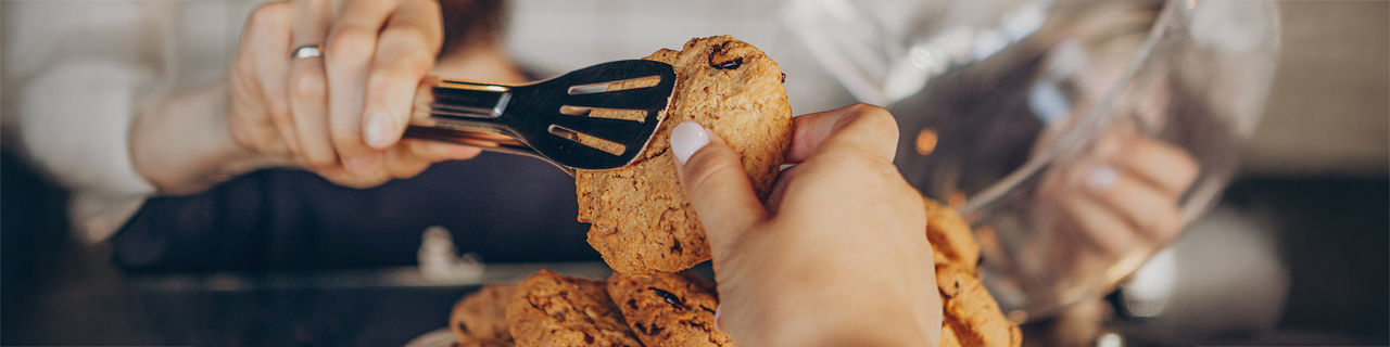 Man serving delicious sweets at local bakery. 