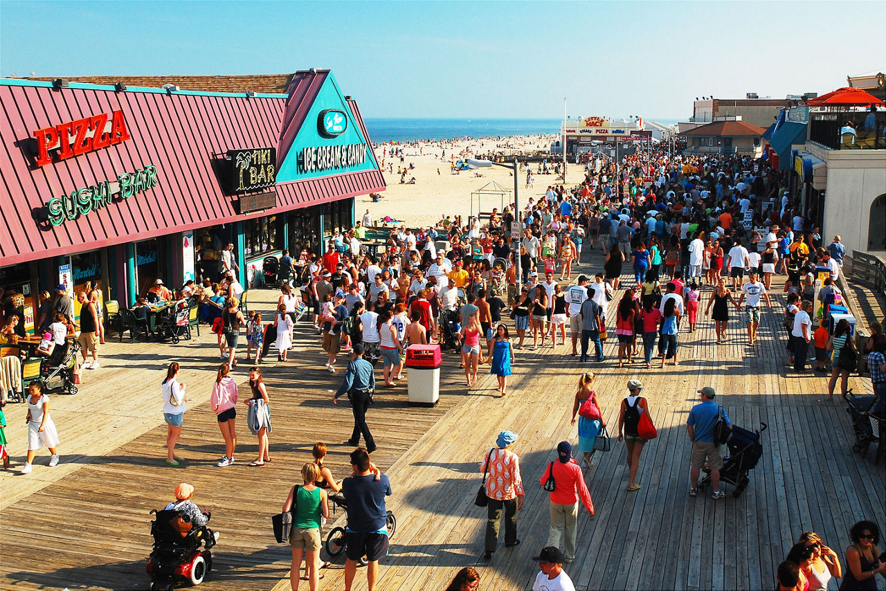 A large crowd of people enjoy a beautiful fay on the boardwalk in Point Pleasant, New Jersey