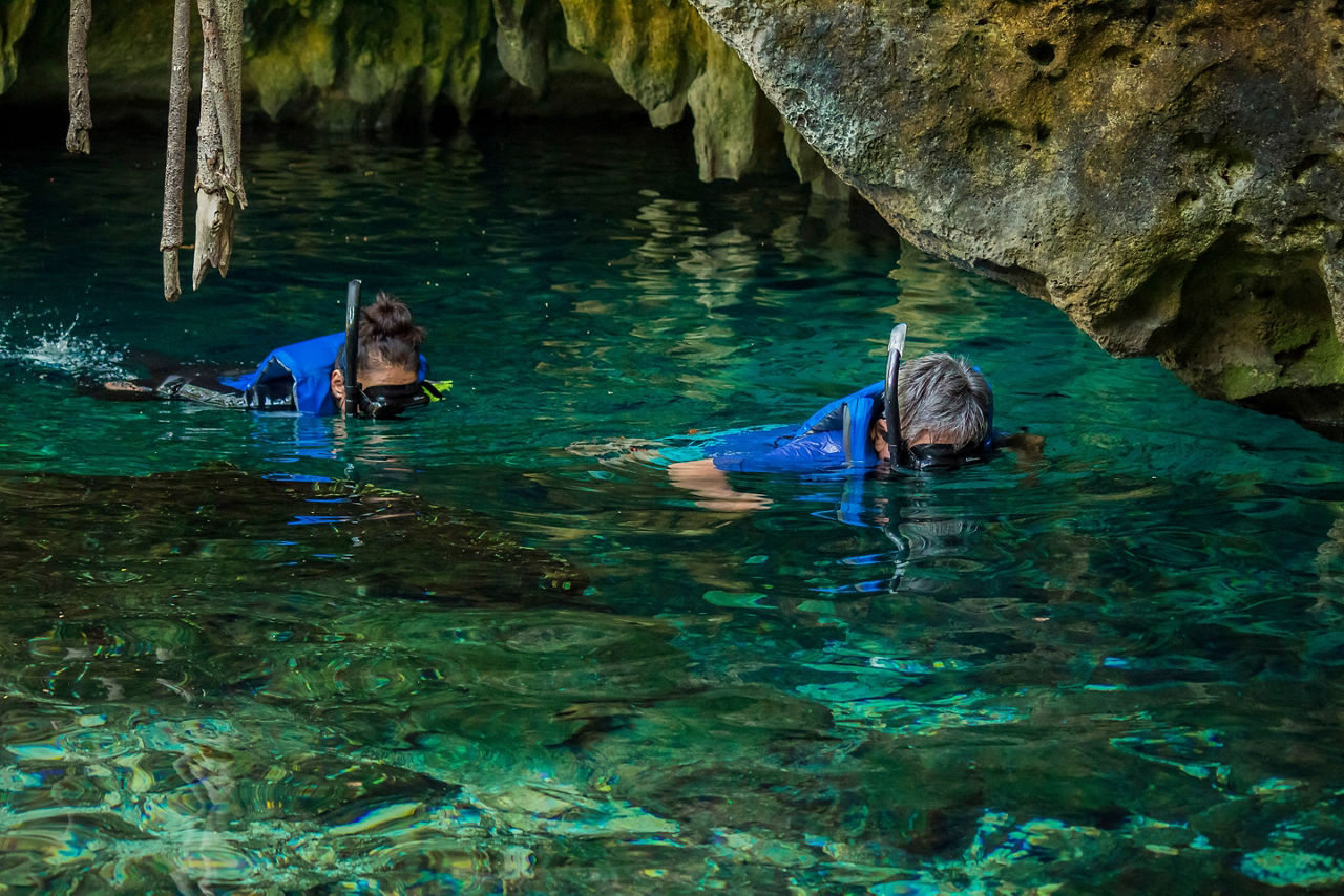 People snorkeling on a cenote in Cancun Mexico