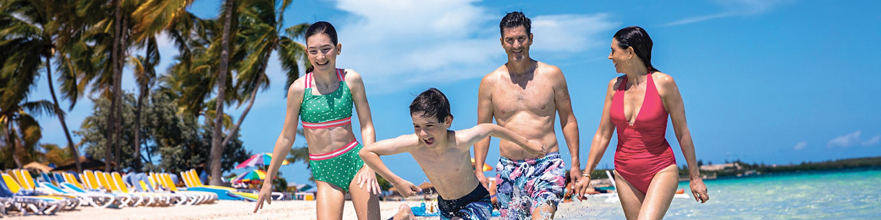 RBC Paradise Island, family fun, mom, dad, and two kids walking in water near shore, beach