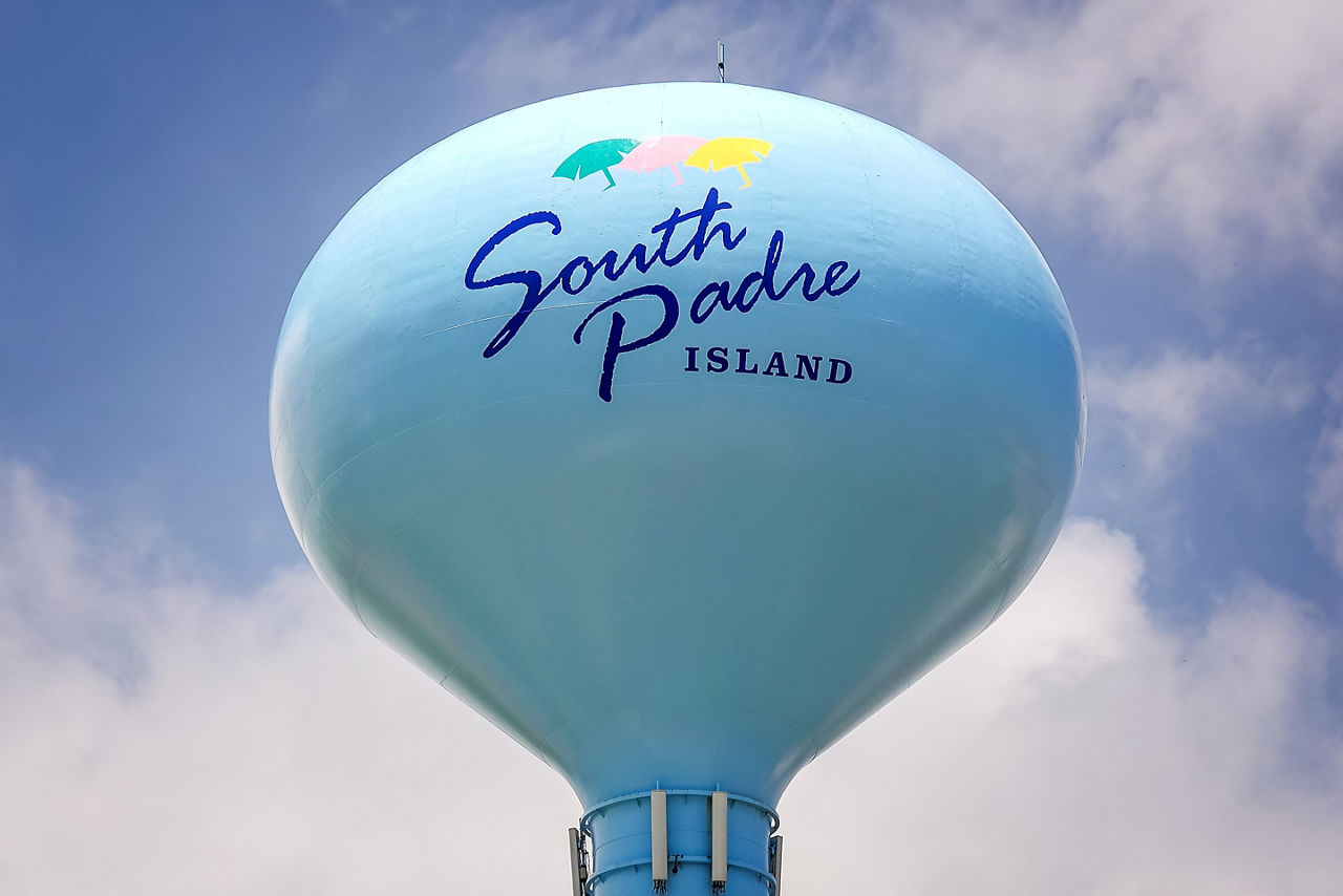 South Padre Island sign painted on blue water tower