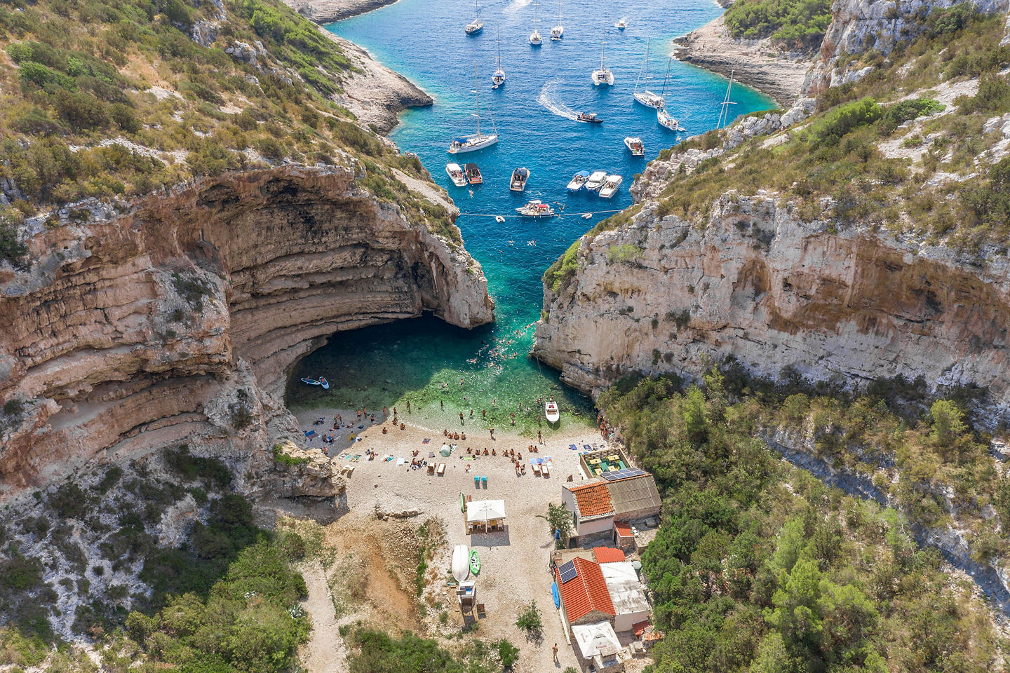Stiniva Cove’s narrow entrance opens to bright turquoise sheltered waters. - Dubrovnik, Croatia