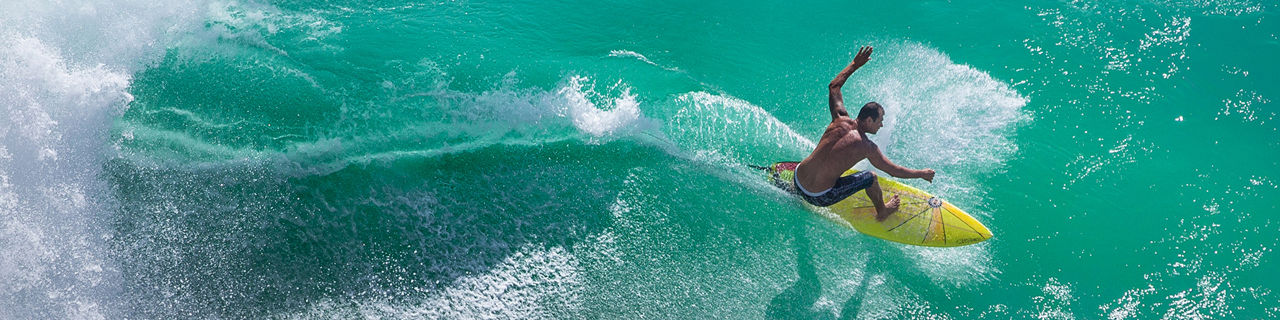 Surfer Riding a Big Wave at Padang Padang Beach, Bali, Indonesia.