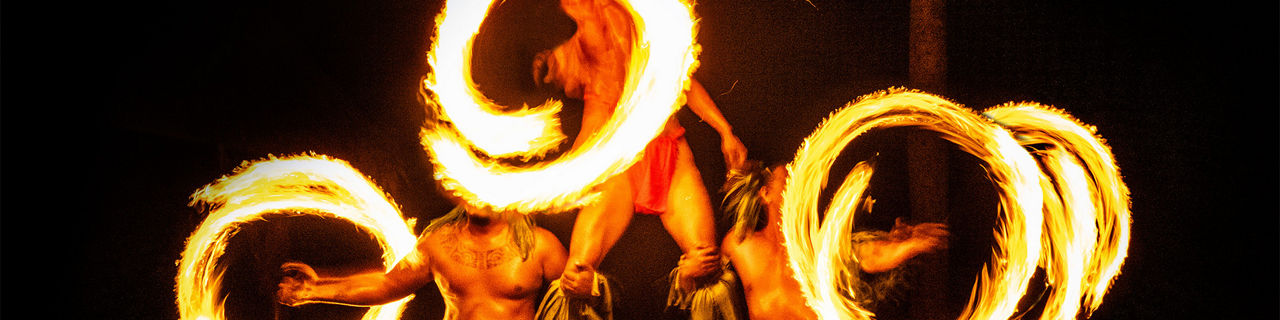 Three Hawaiian fire dancers at a traditional Luau, Hawaii