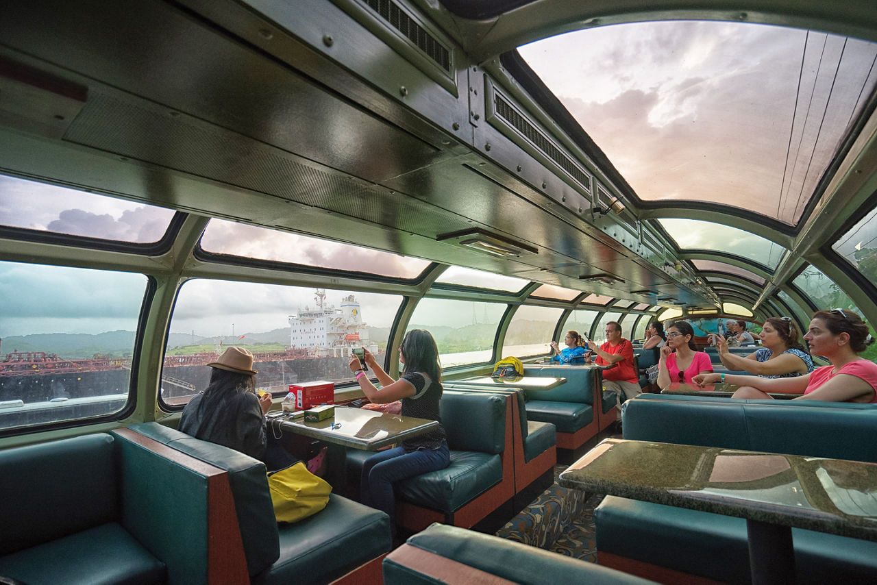 Tourists taking photos from inside the Panama Railway