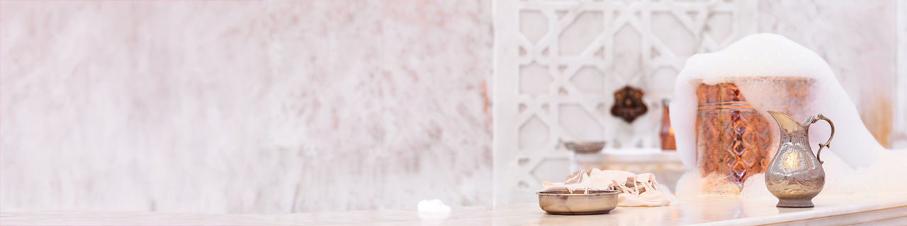 Water jar, towel and copper bowl with soap foam in turkish hamam