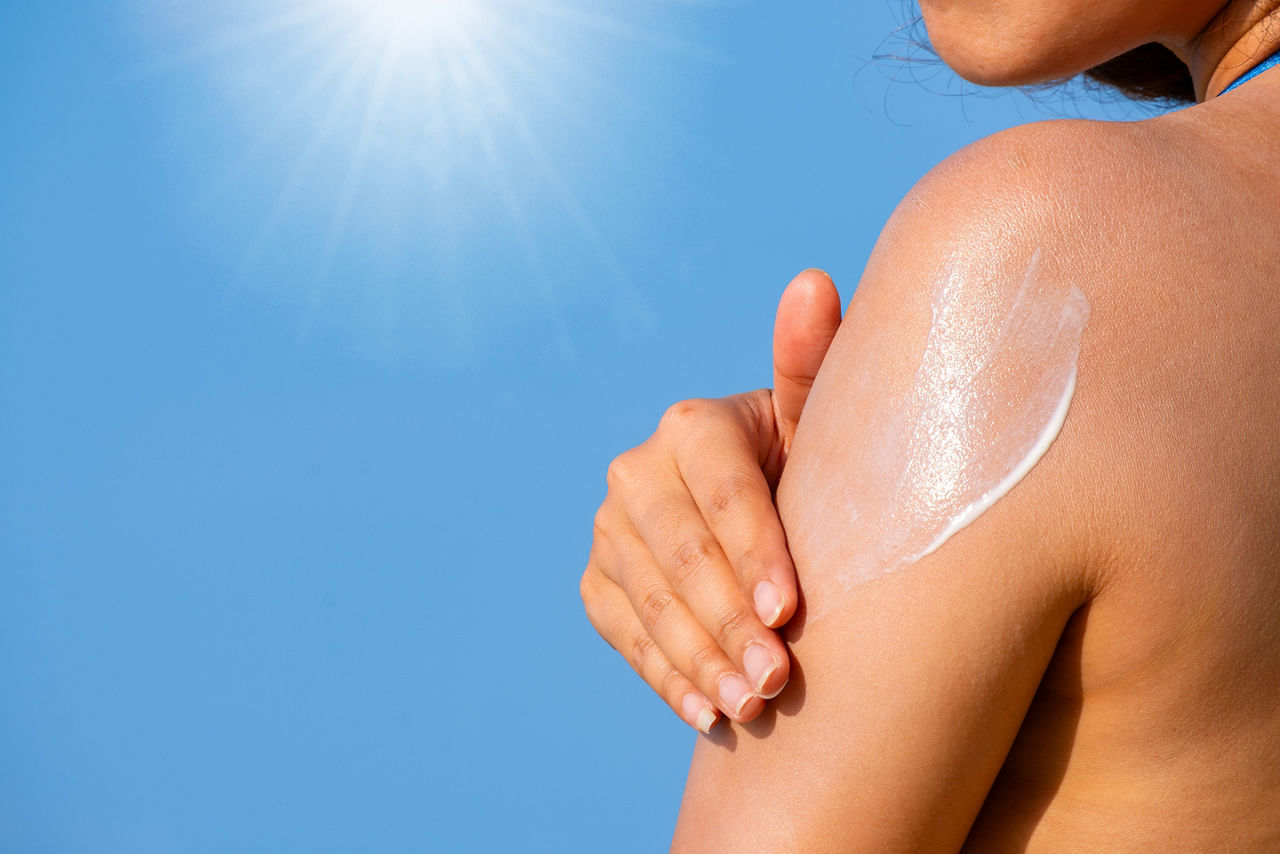Woman applying sunscreen