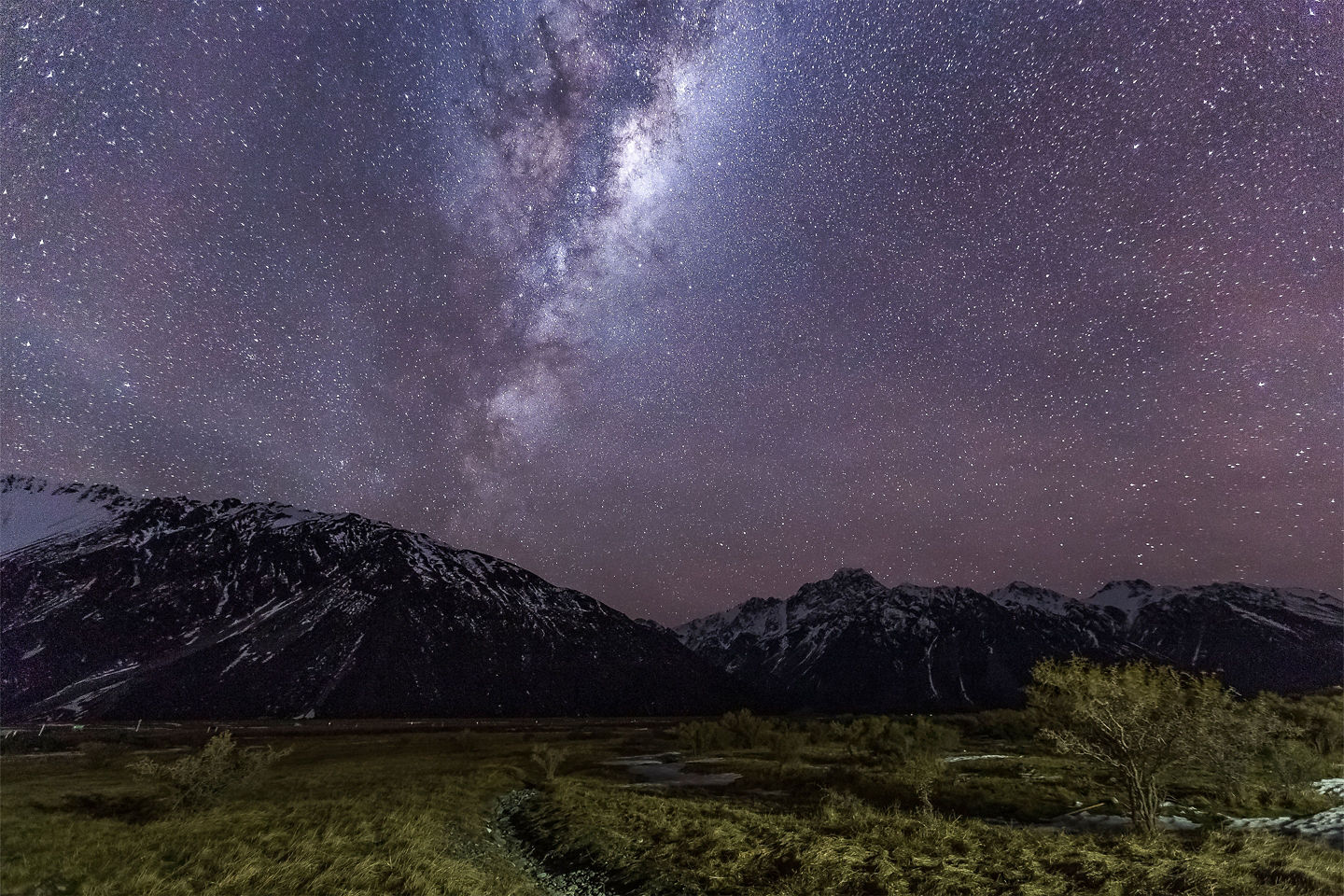 Milky Way arcs above snowy peaks in Aoraki Mackenzie. - Mount Cook National Park, New Zealand