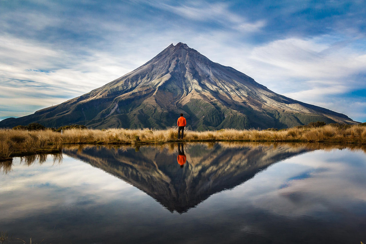 Man Standing In Front Of New Zealand Peak