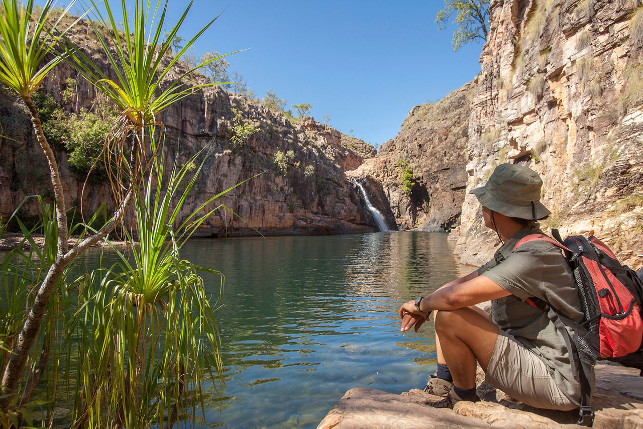 Woman sitting in the rock pool at the Barramundi falls, Kakadu National Park, Northern Territory, Australia