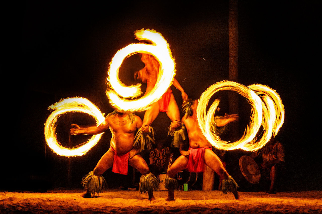 Three Hawaiian fire dancers at a traditional luau. Hawaii