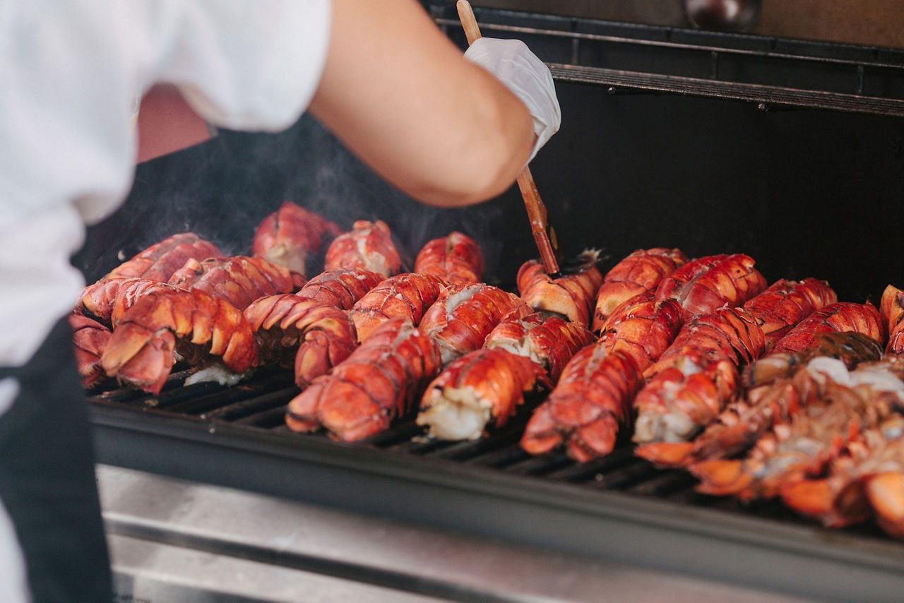 Cook brushing lobsters.