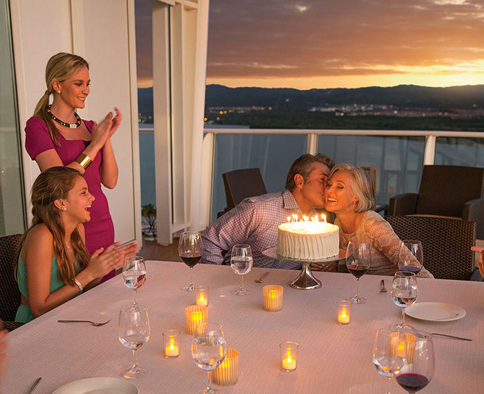 Family celebrating a birthday or special occasion during a vacation on a cruise.