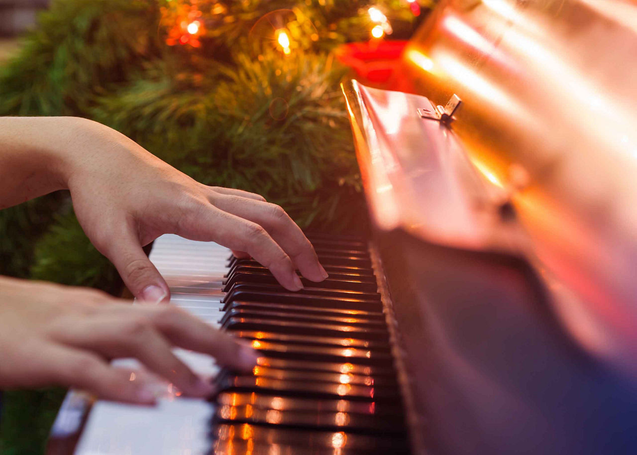 Hands Playing Piano Part of Caroling and Music on Christmas Cruises