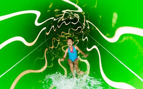 LB, Liberty of the Seas, revite 2016, Perfect Storm green waterslide, slide interior, young girl laughing as she comes down inside slide, family fun, excitement, action