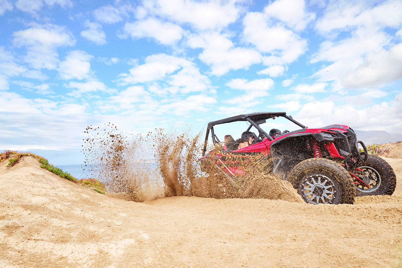 West Coast, couple having fun with dune buggy, coastline, mountains, sightseeing