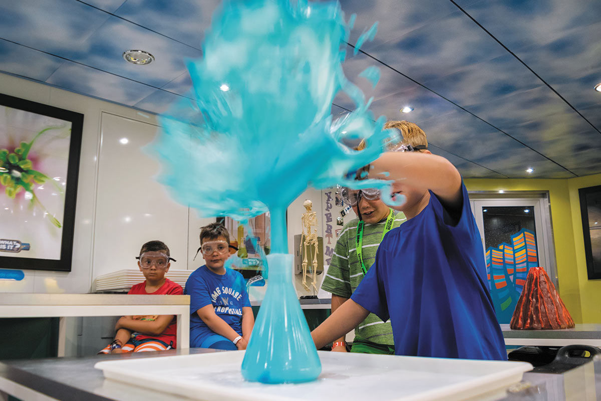 Kids playing with a volcano experiment at the Adventure Ocean Lab
