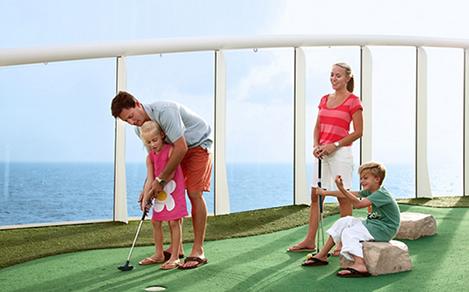 Family playing mini golf on a cruise. A cruise activity for families with children.