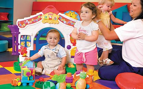 Toddlers in a playroom with the best cruise sitters and nursery services.