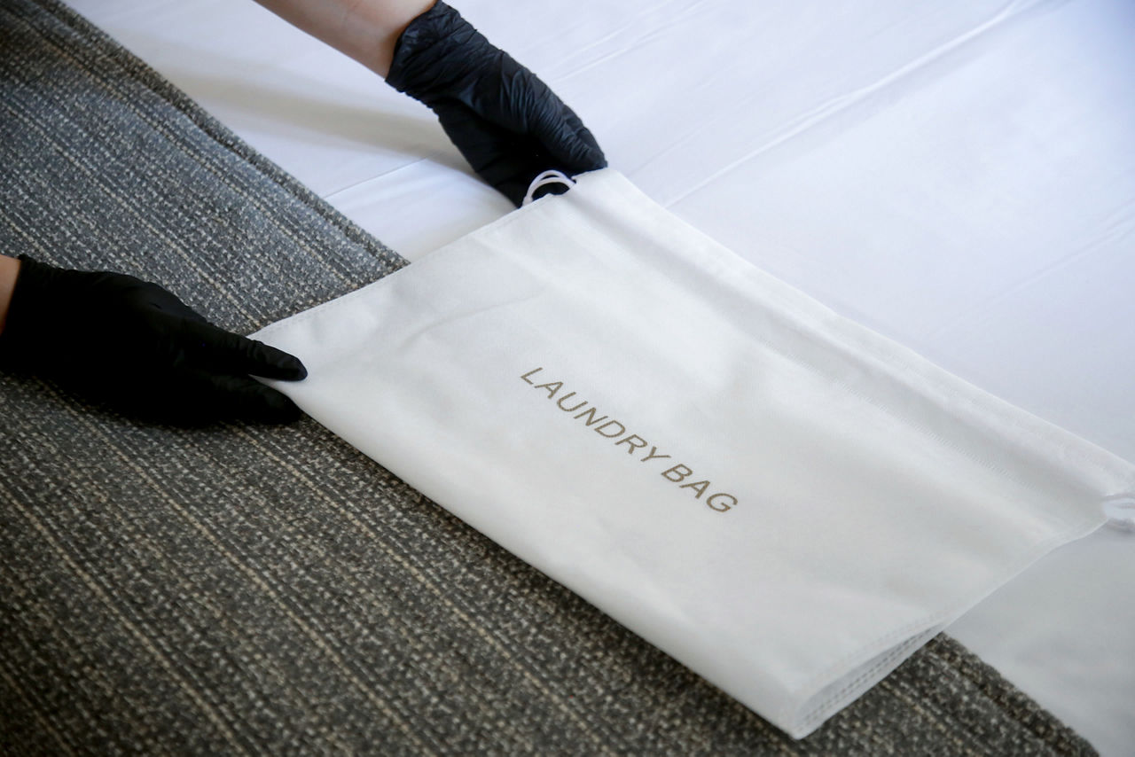 oom staff bringing laundry bag 