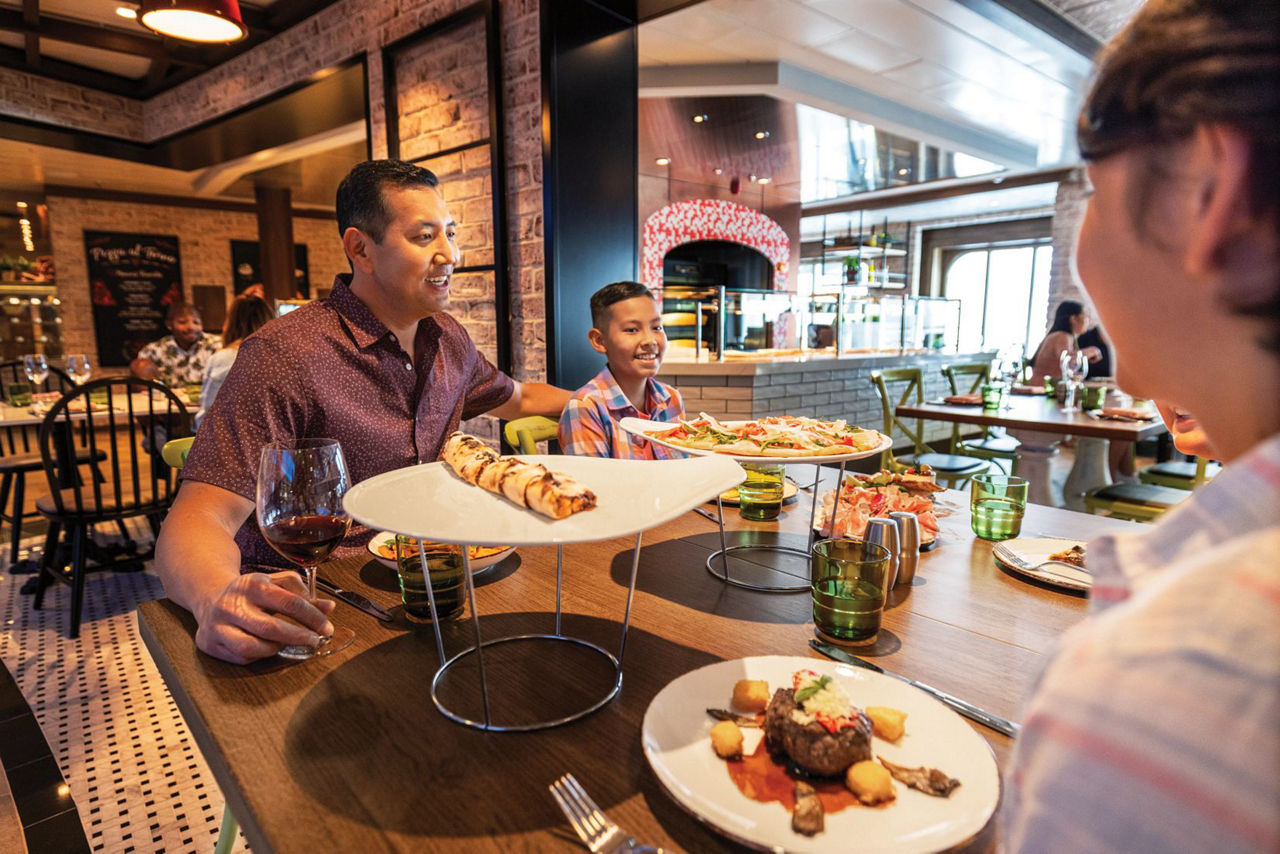 OY, Odyssey of the Seas, October 2021 Content Creator shoot, Giovanni's, restaurant, italian, food, pizza, wine, family at table enjoying dinner, interior