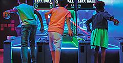 Arcade Kids Playing Skeeball