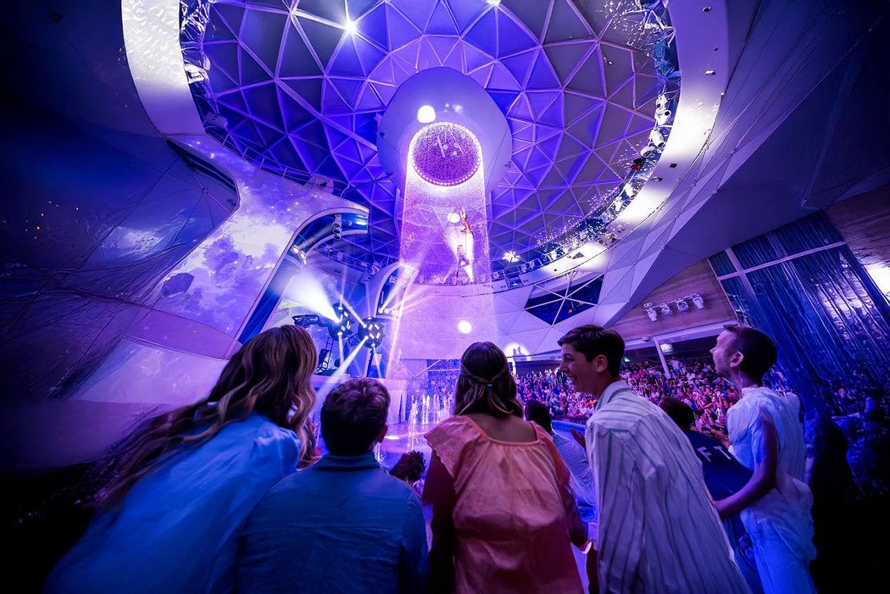 Family watching the Aqua Action performance at the Aqua Theater