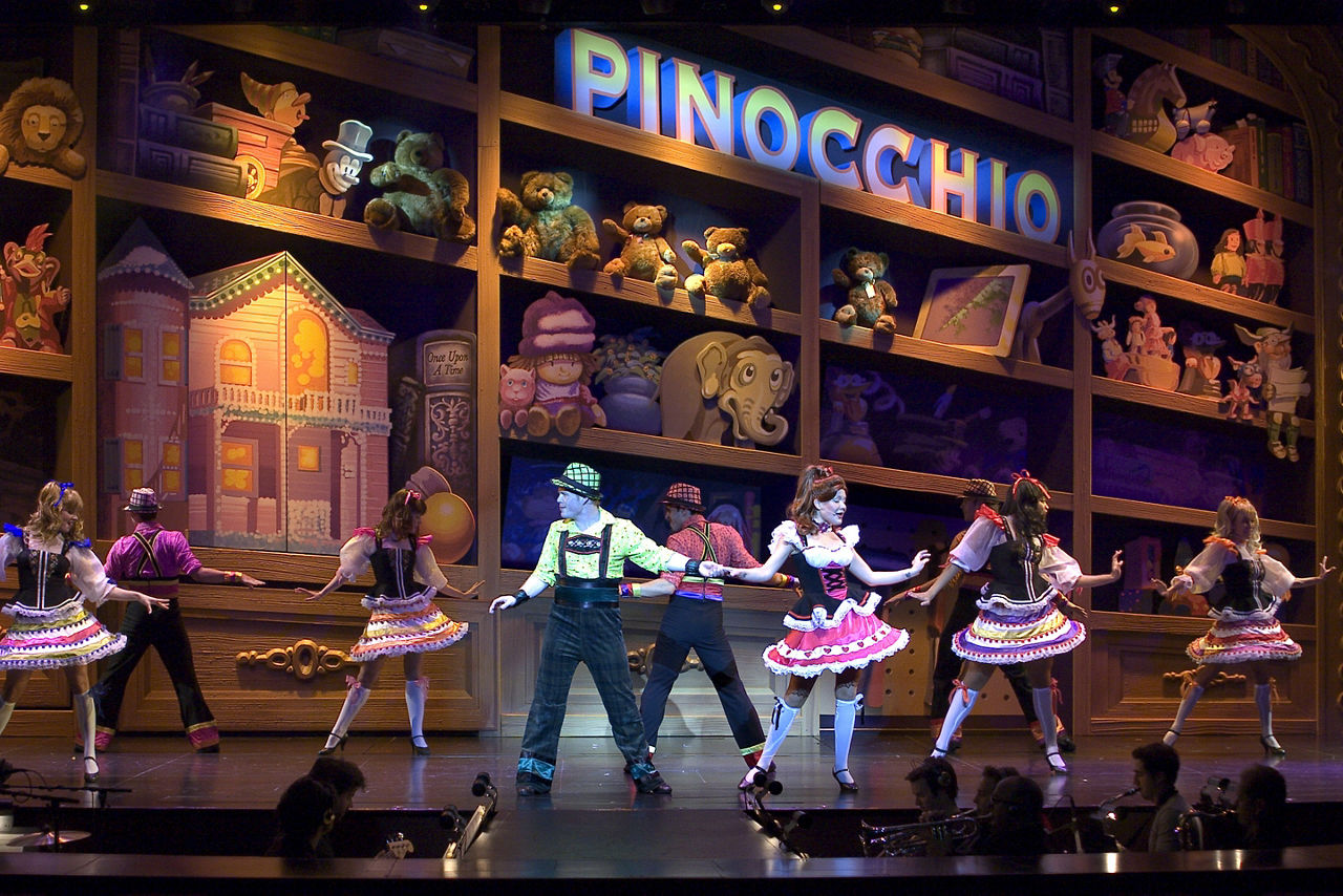 Freedom of the Once Upon a Time Cruise Show, Performers  in dresses dancing on Pinocchio stage