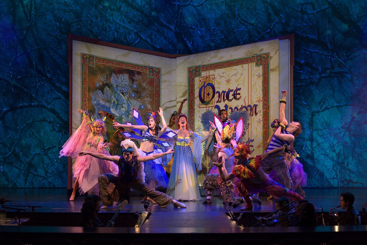 Freedom of the Once Upon a Time Cruise Show, Performers on Stage With A book Behind them
