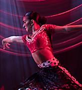 Salsa dancer on stage during an original production cruise show by Royal Caribbean