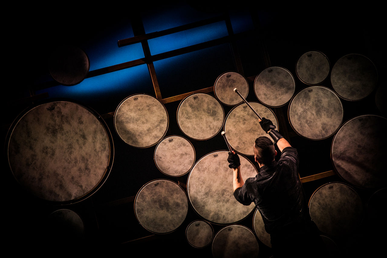A man is drumming during the Sonic Odyssey Cruise Show by Royal Caribbean
