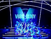 Performers on blue stage during the Vibeology Cruise Show on Serenade of the Seas