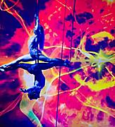 Two performers suspended doing aerial acrobat tricks during the Starwater show on Quantum.