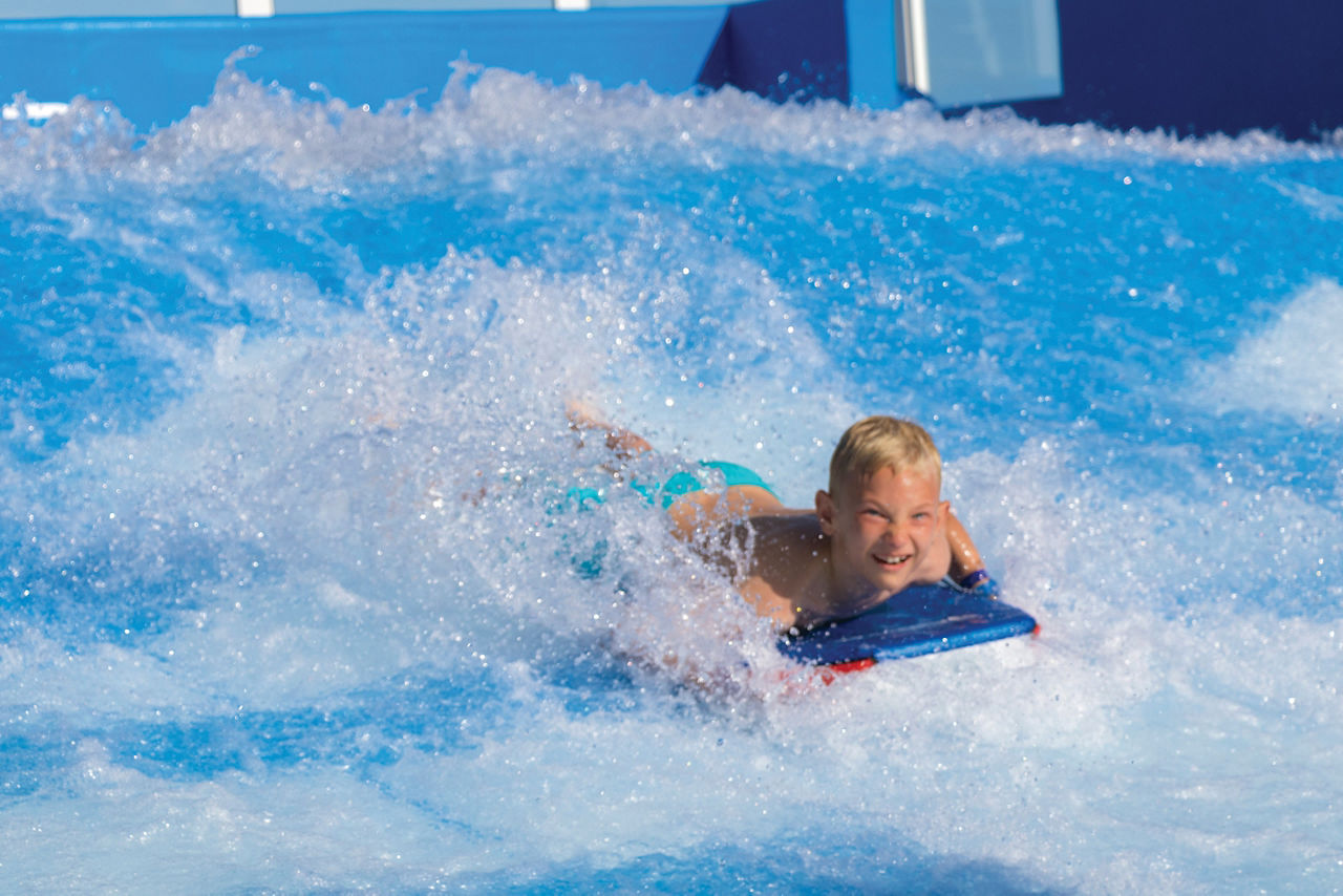 Harmony of the Seas Boy Body Surfing on Flowrider Laughing