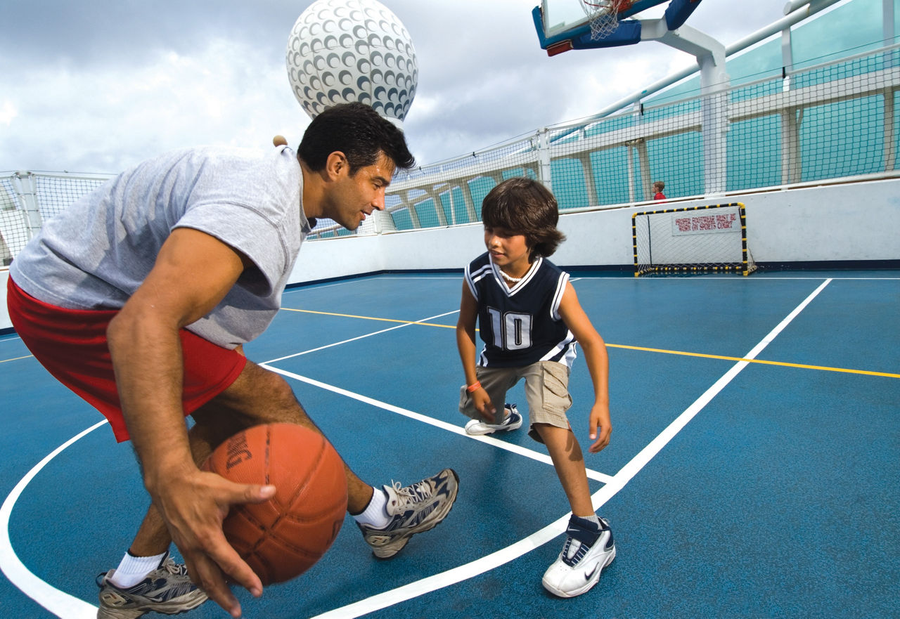 Father and Son Playing Basketball in the Sports Court 