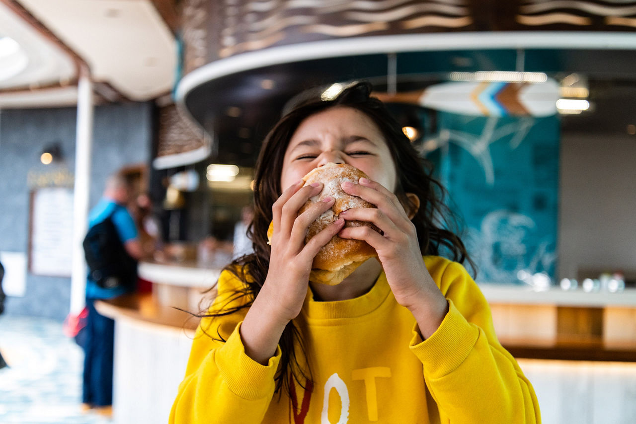 Girl Enjoying a Fish Sandwich