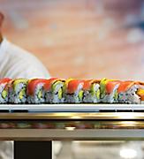 Sushi Chef Serving a Salmon Roll