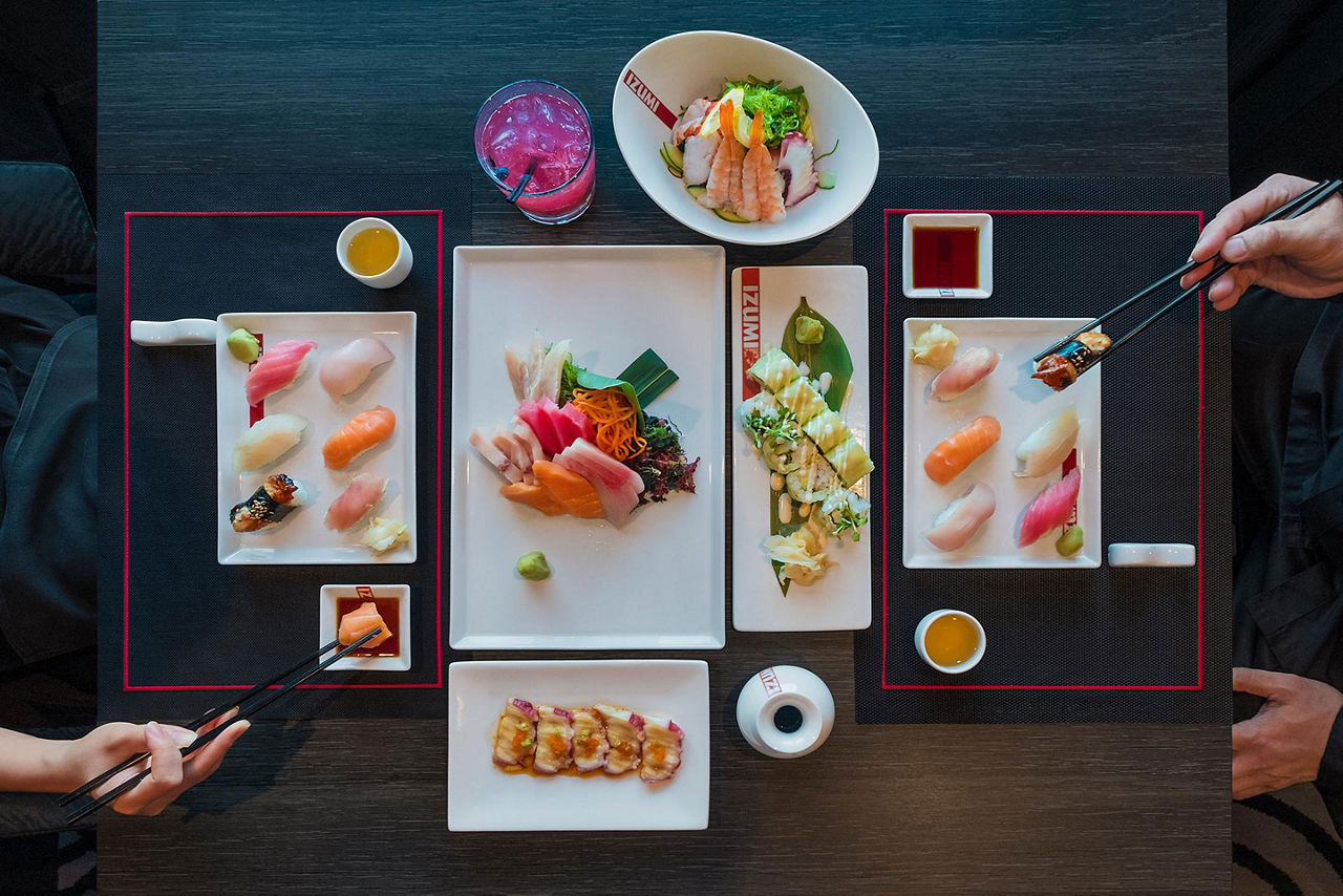 A top-down view of assorted dishes on a table at Izumi on a Royal Caribbean ship