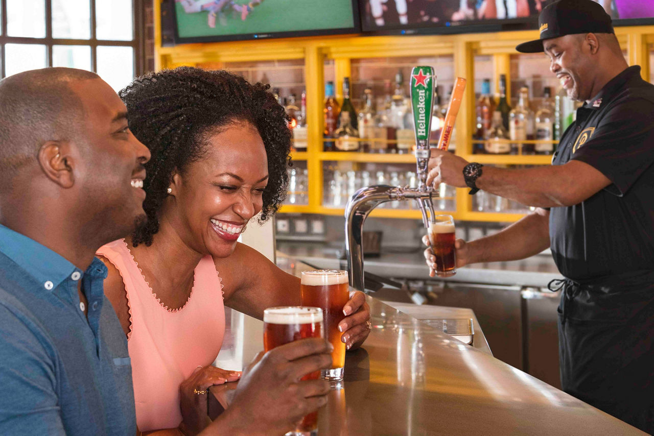 Symphony of the Seas Playmakers Couple Enjoying Draft Beer 