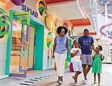 A happy family entering Sugar Beach Candy Store 