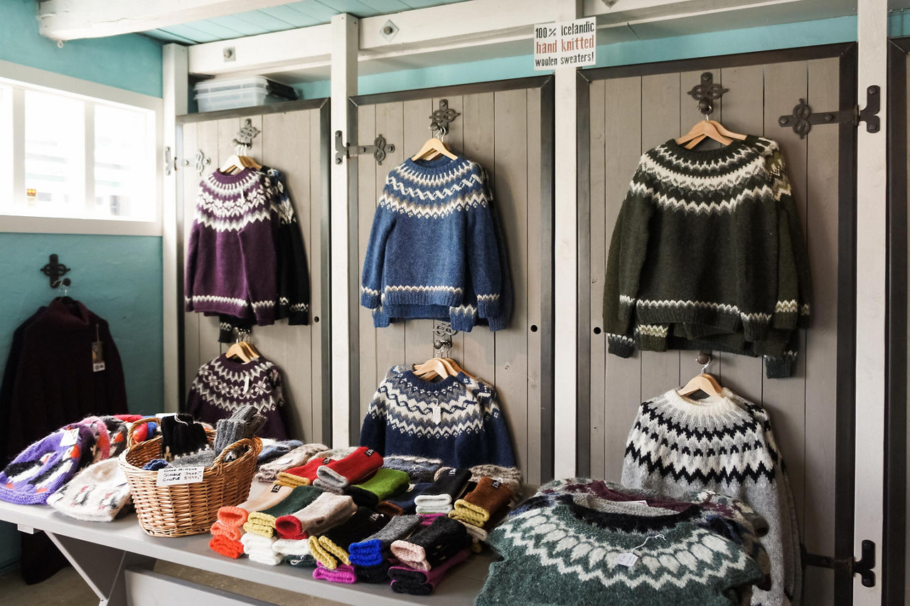 An assortment of wool sweaters at a store