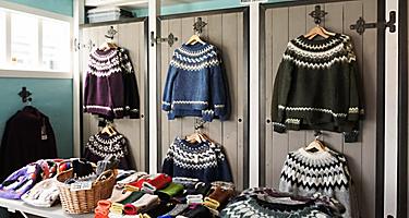 An assortment of wool sweaters at a store