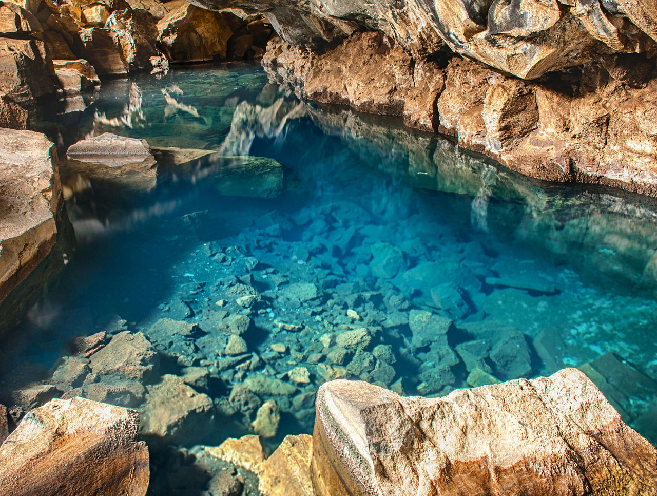 Clear blue water within a cave in Iceland