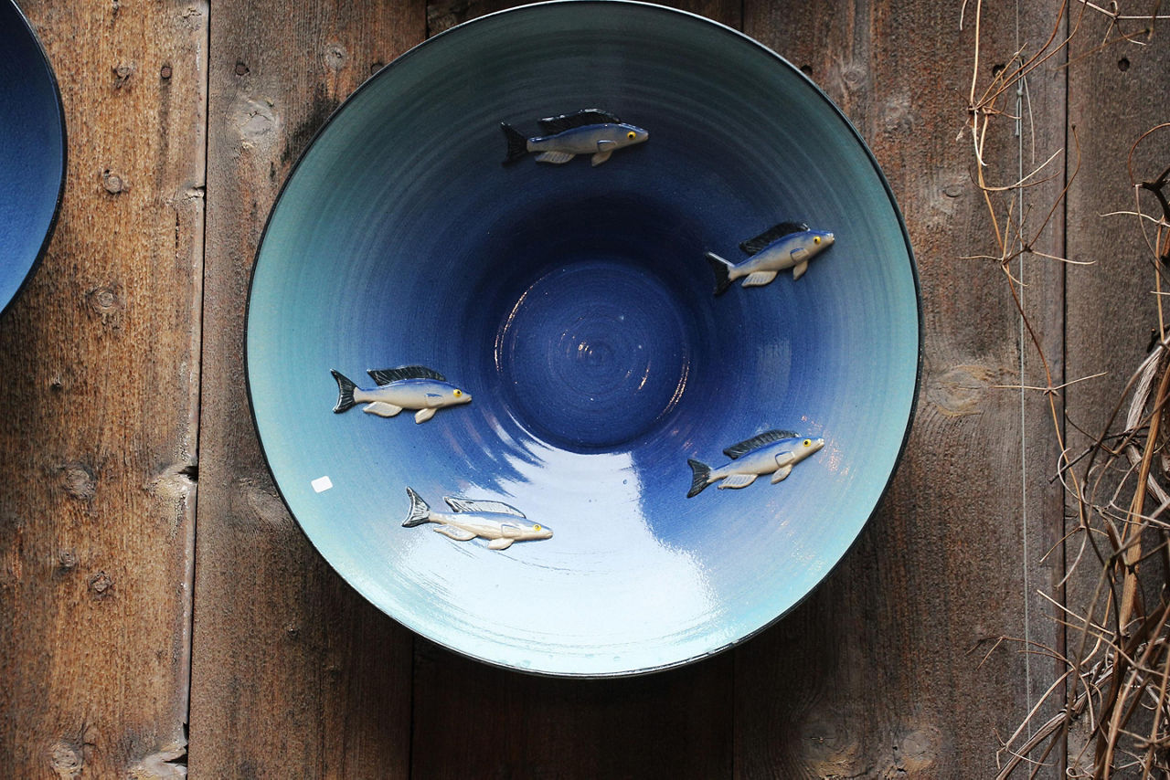 A blue traditional Norwegian bowl with fish decorations