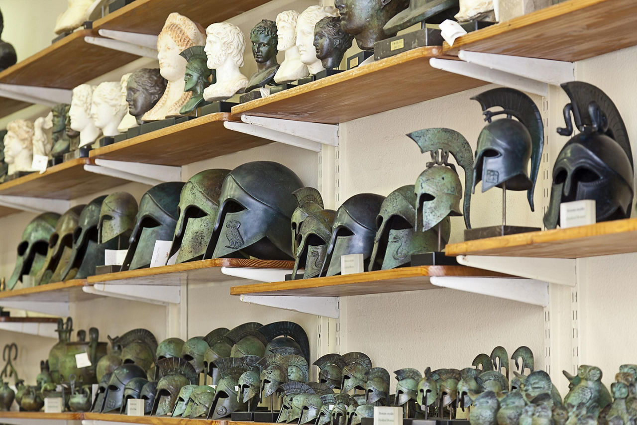 An assortment of Greek souvenirs such as helmets and sculptures