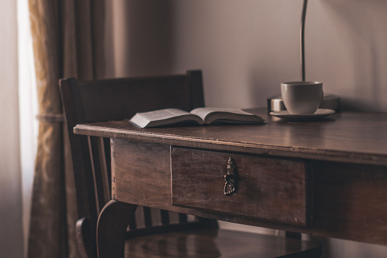 Antique table in a dark room with a lamp